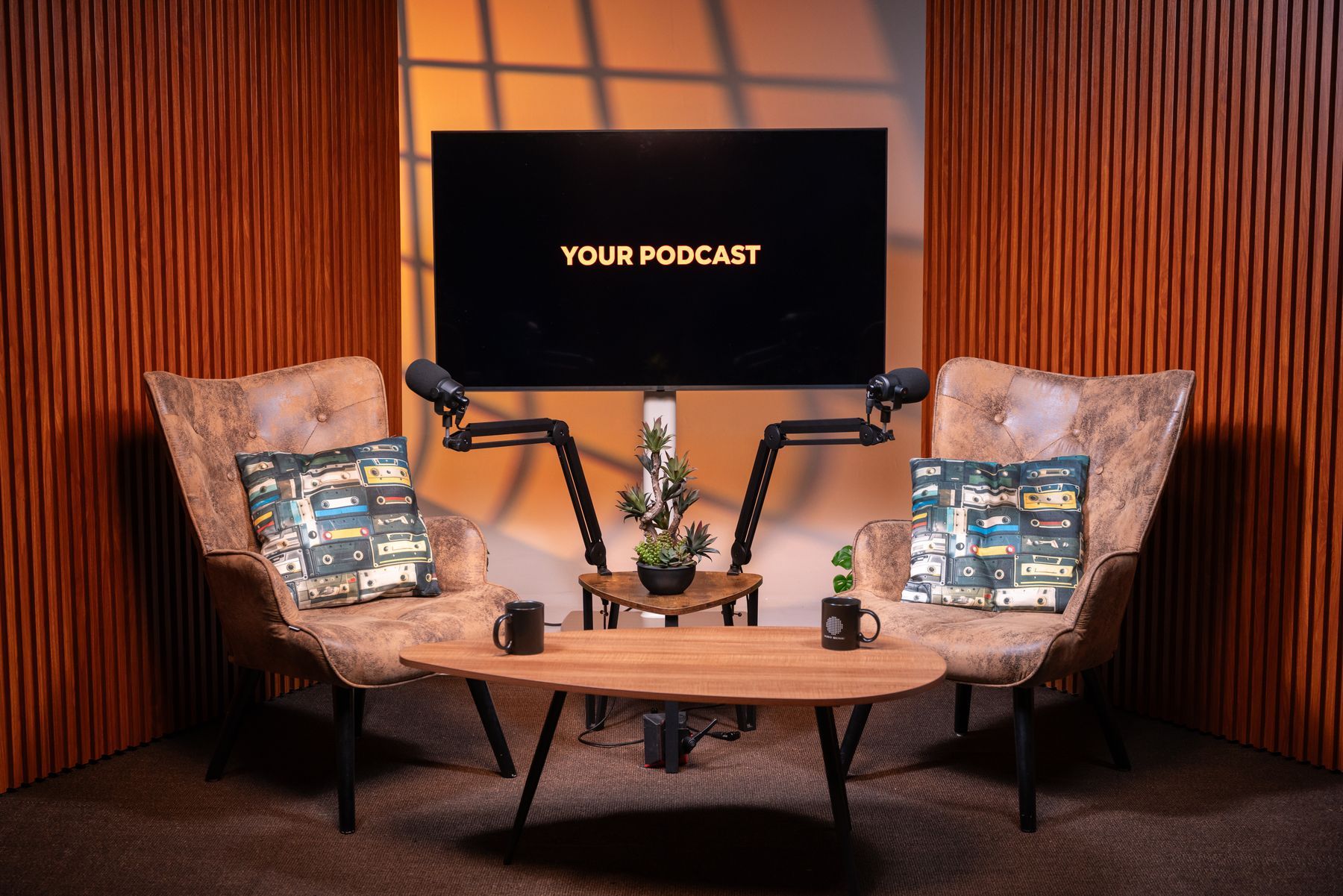 Interview podcast set with leather armchairs and warm amber lighting at KSM Podcast Studio Miami