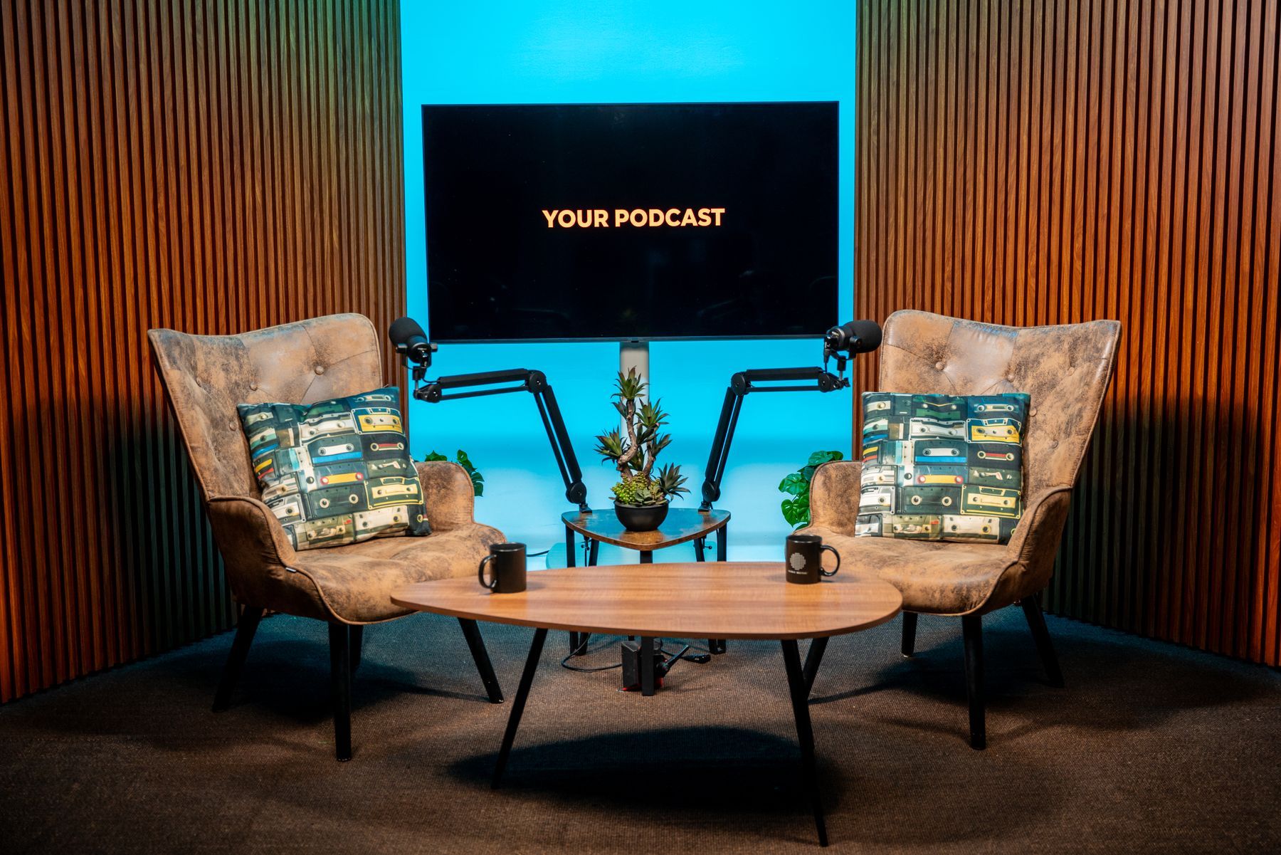 Two-guest video podcast interview set with blue backdrop in a Miami podcast studio